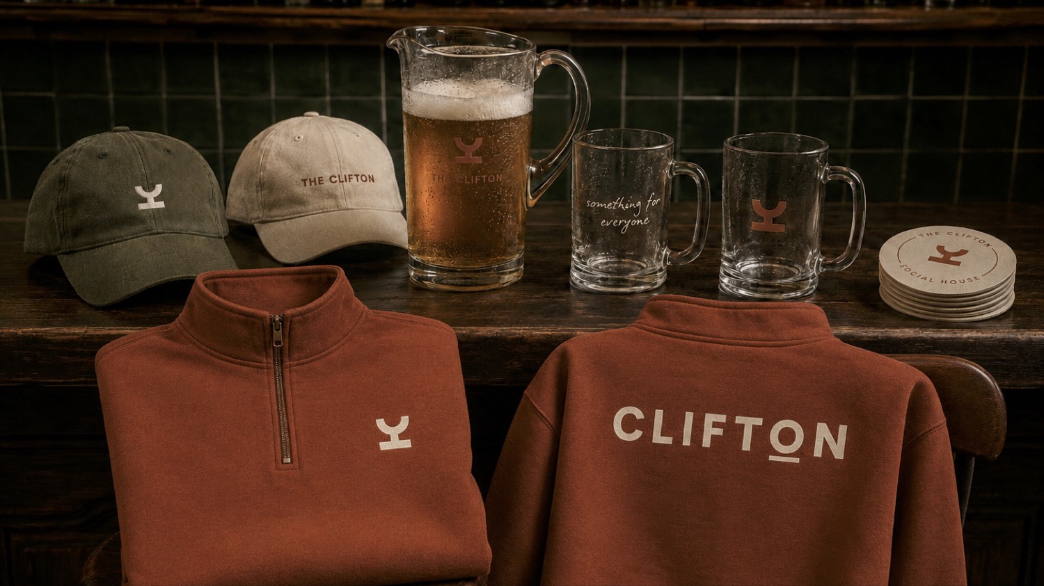 Rust and olive Clifton quarter-zips and caps on a bar