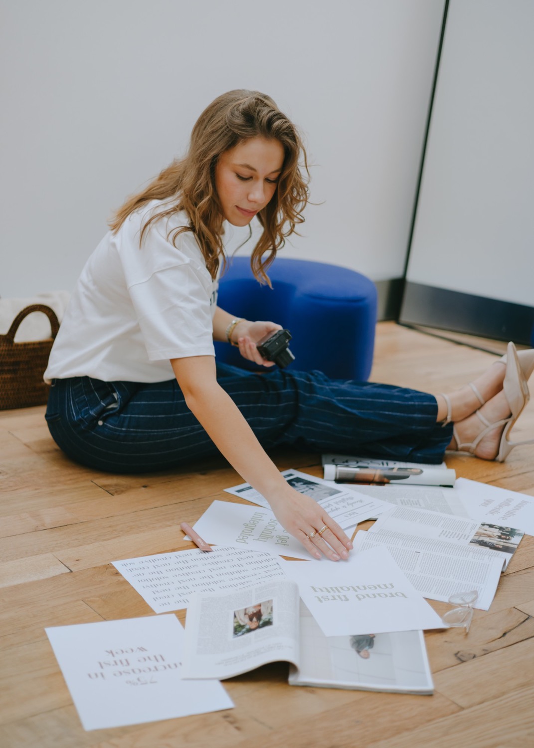 Taylor Petersen laying out printed brand materials on the floor