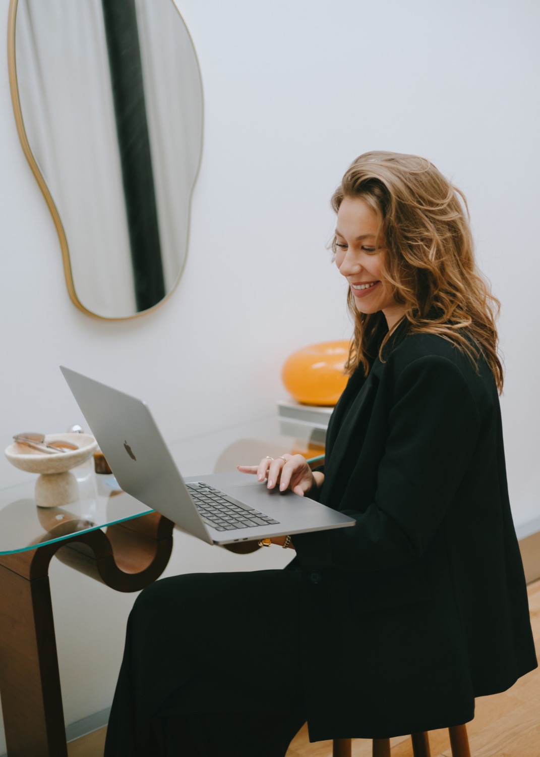 Taylor Petersen smiling at a laptop