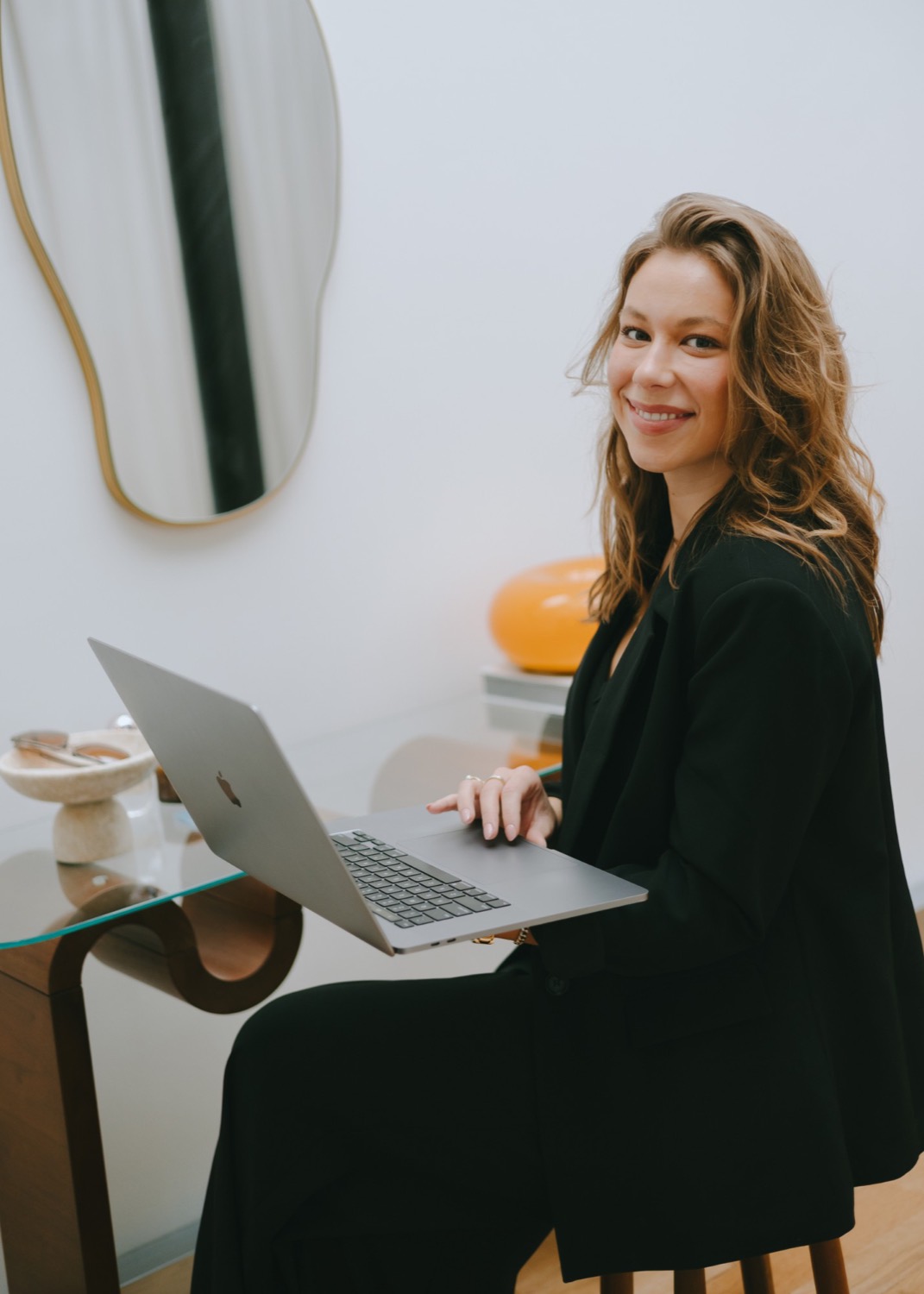 Taylor Petersen smiling, laptop on lap