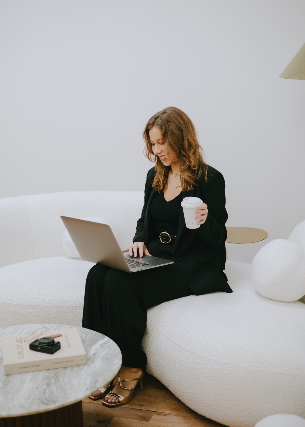 Taylor Petersen working on a laptop with a coffee