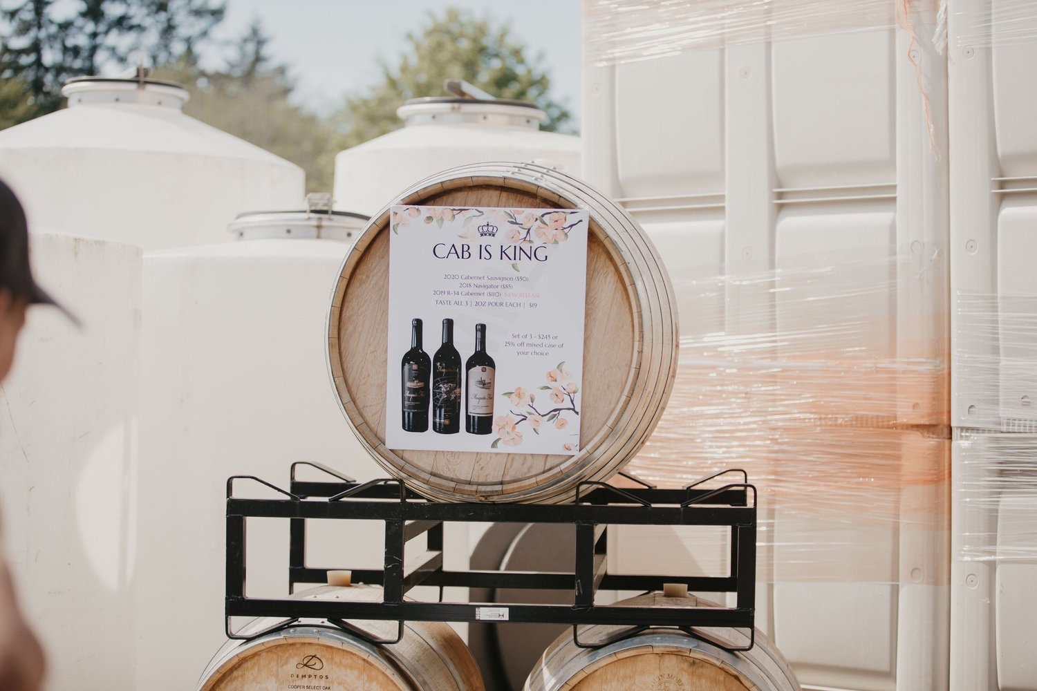 Event signage among wine barrels at Mosquito Fleet Winery